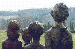 Children are looking towards the common grave of their fathers, grandfathers and friends.